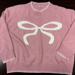Pink Sweater with White Bow Design